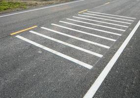 witte dwarse rumble strips op de asfaltweg. foto