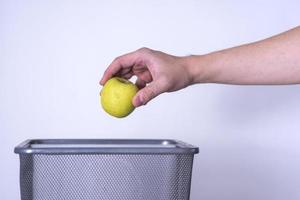 appel gegooid in de afval, voedsel afval. foto