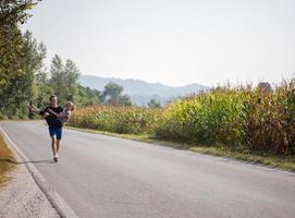 gelukkig paar joggen langs een landweg foto