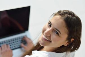 ontspannen jong vrouw Bij huis werken Aan laptop computer foto