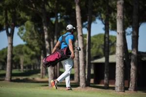 golf speler wandelen en draag- zak foto