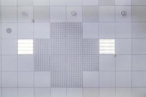 cassette verlaagd plafond met vierkante halogeenspots lampen en gipsplaten constructie in lege ruimte in appartement of huis. spanplafond wit en complexe vorm. omhoog kijken foto