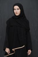 modern jong moslim vrouw in zwart abaya foto