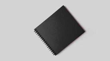 leeg zwart notitieboekje mockup met zacht schaduwen Aan neutrale grijs beton achtergrond. foto
