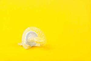 wit baby siliconen fopspeen Aan een geel achtergrond. kopiëren ruimte. foto