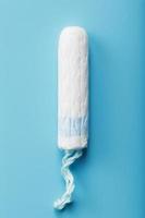 hygiënisch tampon Aan een blauw achtergrond met een vrij ruimte foto