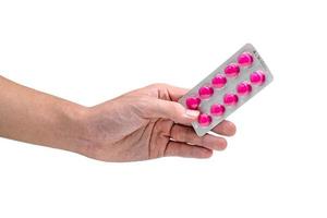 hand- Holding blaar pak van roze tablets pil geïsoleerd Aan wit achtergrond foto