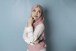 portret van een glimlachen jong moslim vrouw vervelend roze hijab op zoek terzijde foto