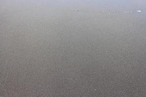 zand op het strand als achtergrond foto