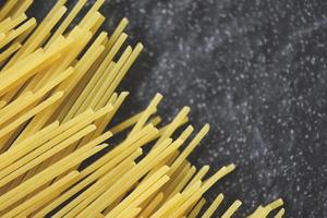 rauwe spaghetti italiaanse pasta ongekookte spaghetti geel lang klaar om te koken in het restaurant italiaans eten en menu foto