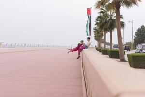 moeder en schattig weinig meisje Aan de promenade door de zee foto