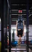 vrouw werken uit Aan gymnastiek- ringen foto