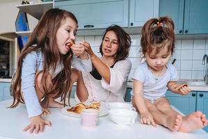 mam en twee dochters eten pannekoeken foto