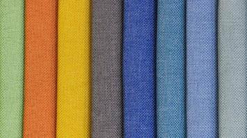 kleurrijk achtergrond, een stack van kleurrijk kleding stof. naaien naadloos structuur achtergrond kleurrijk verzameling kleding stof foto