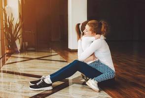 moeder en dochter knuffelen in de Sportschool foto