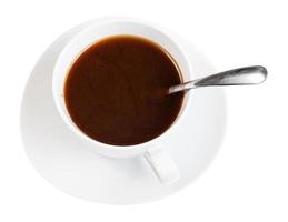 koffie drinken in wit kop met lepel Aan schotel foto