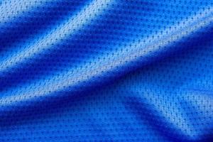 blauwe kleur stof sportkleding voetbal trui met lucht mesh textuur achtergrond foto