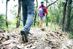 jonge toeristische paar kijken naar een spectaculair berglandschap in de hoge bergen. man en vrouw wandelaar op de bovenste rots. een paar verliefde reizigers. mensen begroeten de dageraad. geliefden reizen. kopieer ruimte foto