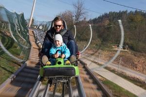 vader en zoon geniet het rijden Aan alpine kustvaarder foto