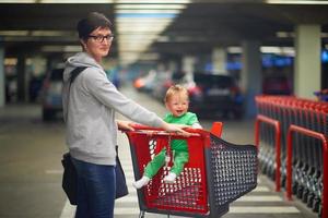 moeder met baby in boodschappen doen foto