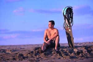 portret van een jong kitsurfen Mens Bij strand Aan zonsondergang foto