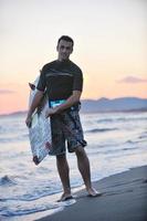 portret van een jong kitsurfen Mens Bij strand Aan zonsondergang foto