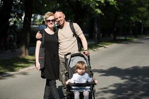 paar met baby kinderwagen in zomer park foto