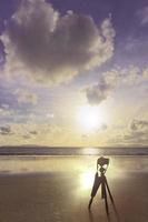 fotograaf en camera Aan staan en strand Bij zonsondergang en liefde hart wolk foto