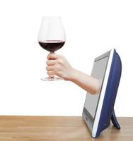 hand- verhogen groot glas met rood wijn leunt uit TV foto