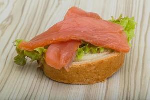 Zalm belegd broodje Aan houten achtergrond foto