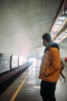 vent staand Bij station in medisch beschermend masker Aan zijn gezicht. foto