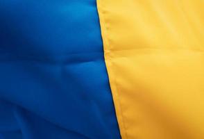 kleding stof gebogen vlag van Oekraïne. dichtbij omhoog schot, achtergrond foto
