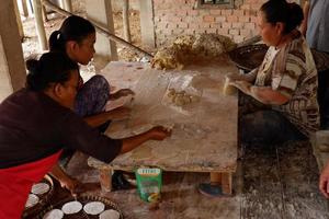 ogan ilir, zuiden sumatera, Indonesië - november 26, 2021, drie Dames produceren crackers en traditioneel voedsel Aan een huis schaal foto