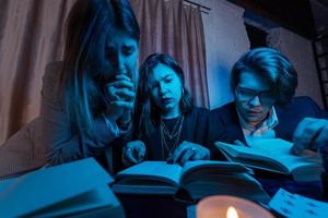 twee Dames en een vent zijn lezing een mysterieus boeken, dichtbij visie foto