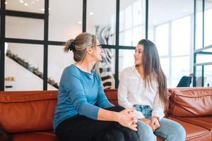 jong vrouw bezoekende grootmoeder Bij huis, Dames praten foto