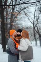 vader mam en baby in de park in winter foto