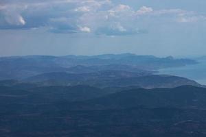 berg landschap, bebost bergen en blauw zee, top visie. foto