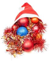 Kerstmis decoratie en klatergoud vallen uit van de kerstman hoed foto