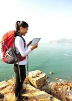 wandelende vrouw gebruik tablet pc aan zee