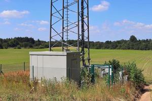 elektrisch antenne en communicatie zender toren in een noordelijk Europese landschap tegen een blauw lucht foto