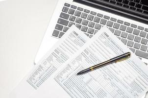belasting het formulier visie met pen, rekenmachine en laptop foto