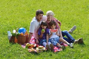 gelukkig familie spelen samen in een picknick buitenshuis foto