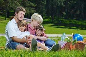 gelukkig familie spelen samen in een picknick buitenshuis foto