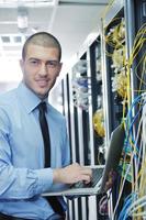 zakenman met laptop in netwerk server kamer foto