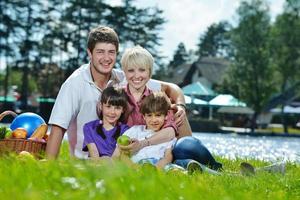 gelukkig familie spelen samen in een picknick buitenshuis foto