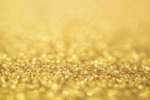 abstracte gouden glitter feestelijke kerst textuur achtergrond vervagen met bokeh licht foto