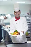 chef in hotel keuken voorbereidingen treffen en decoreren voedsel foto