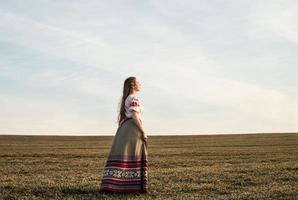 jonge vrouw in Slavische Wit-Russische nationale oorspronkelijke pak buitenshuis
