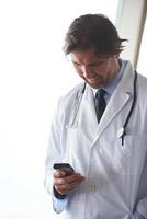 dokter sprekend Aan mobiele telefoon foto