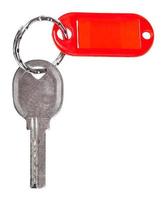 oud deur sleutel met rood blanco sleutelhanger geïsoleerd foto